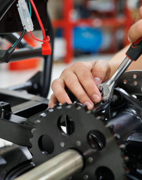 Worker make a ATV in the workshop. Preparing the quad bike for sale